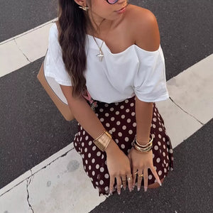 Dark brown polka dot A-line skirt with a bow detail.