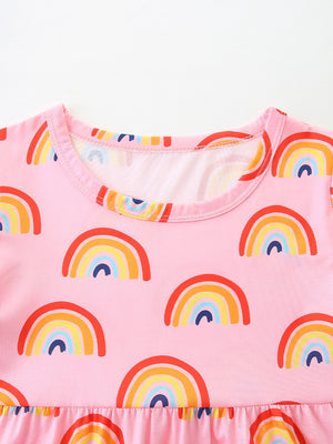 Toddler pink cotton blend dress with rainbow print and ruffled hem detail.