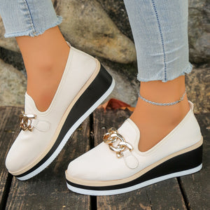 Beige chain decor wedge loafers with a textured finish and black platform sole.