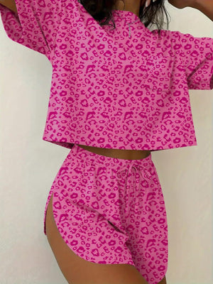 Pink leopard print pajama set with drawstring shorts and short sleeve top.