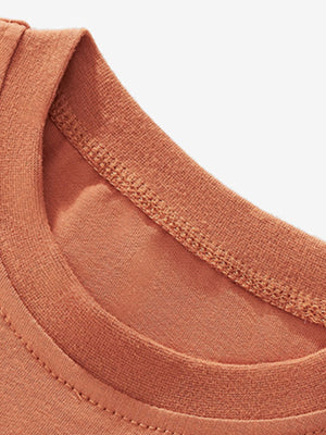 Toddler tee neckline detail in rust orange cotton with double-stitched trim.