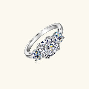 Silver three-stone cushion cut moissanite ring with sparkling stones.