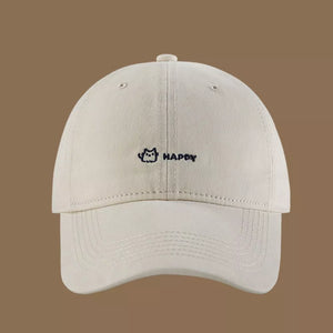 Cream white cotton baseball hat with embroidered cat and happy text.