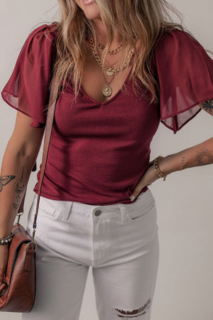 Burgundy ribbed knit top with flutter sleeves and v-neck.