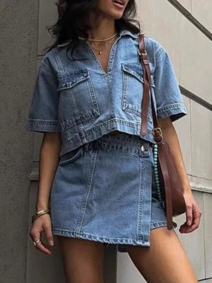 Light blue denim cropped utility shirt and asymmetric skort set with buttoned pockets.