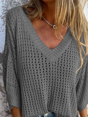 Open-knit V-neck sweater in dark gray with relaxed fit and breathable texture.