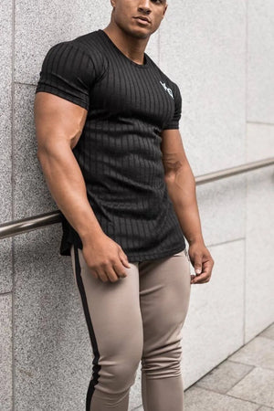 Black ribbed t-shirt with short sleeves and a subtle logo detail on the chest.