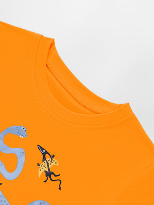 Orange toddler t-shirt with crew neck and dinosaur graphic print.
