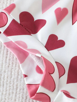 Baby cotton tee and shorts set with pink and red hearts pattern.
