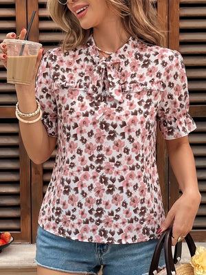 Floral tie-neck ruffle shirt with short puff sleeves and frill trim.