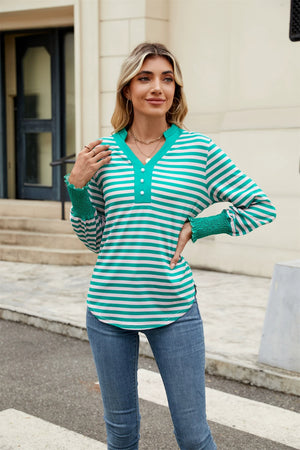 Striped long sleeve blouse in turquoise and white with button detail and smocked cuffs.