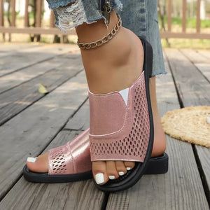 Pink hollow-out slide sandals with a metallic finish and breathable perforated details.