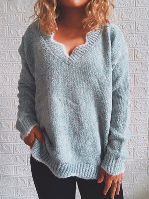 Cloudy blue acrylic v-neck sweater with scalloped trim and ribbed cuffs and hem.