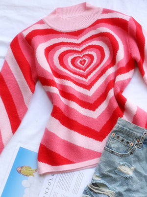 Pink and red striped mock neck sweater with a heart pattern and ribbed neckline.