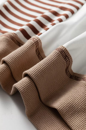 Chic colorblock sweatshirt with brown and white stripes and contrast stitching on ribbed cuffs.