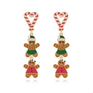 Festive gingerbread man dangle earrings with candy cane tops and red and green outfits.