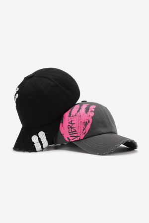 Black and dark gray baseball caps with distressed details and graffiti art.