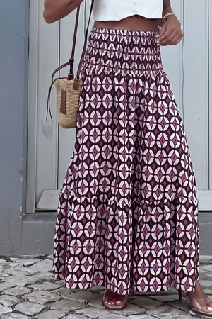 Maxi skirt with smocked waist and geometric print in purple and white.