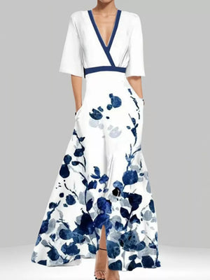 Vibrant floral maxi dress with pockets, V-neck, short sleeves, and a defined waist.
