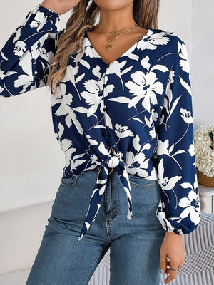 Navy floral knot-front blouse with ruffled cuffs and button detail