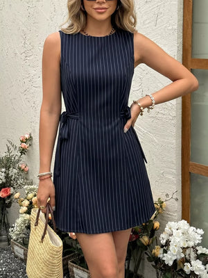 Navy striped tie-waist a-line dress with a round neckline and sleeveless design.