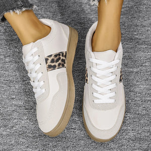 White retro sneakers with leopard print panel detail and white laces.