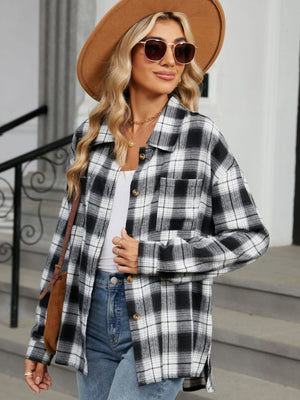 Black and white plaid collared long sleeve shirt with button front and chest pocket.