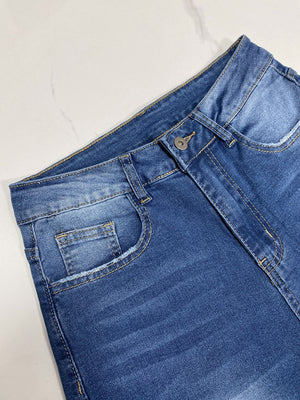 Medium wash wide-leg denim jeans with button fly and contrast cuff detail.