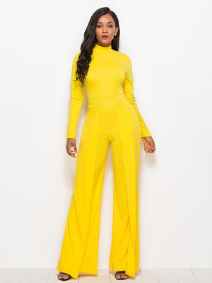 Yellow high-waisted palazzo jumpsuit with slit front and long sleeves.