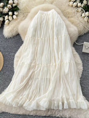 Elegant tiered tulle skirt in apricot with ruffled hem and lining.