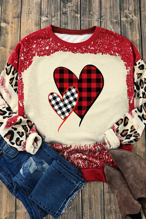 Sweatshirt with plaid heart graphic and leopard sleeves in deep red and cream.