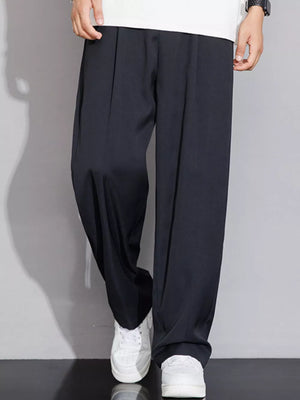 Men's black wide-leg chinos with a relaxed fit and subtle pleats.