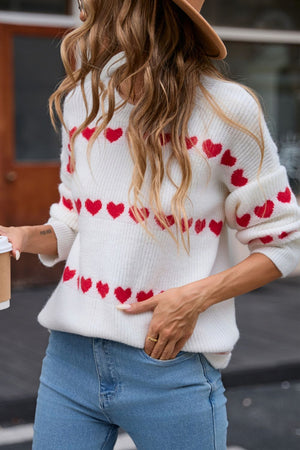 Ivory knit pullover sweater with red heart stripe pattern.