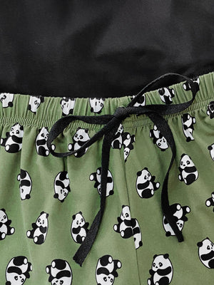Green panda print pajama shorts with drawstring and black top detail.