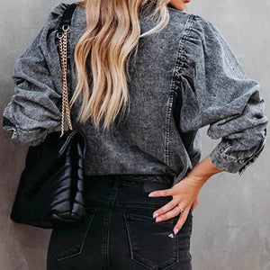 Dark gray acid-washed denim shirt with puffed sleeves and button details.