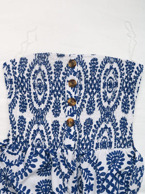Blue bustier jumpsuit with white floral print and decorative buttons