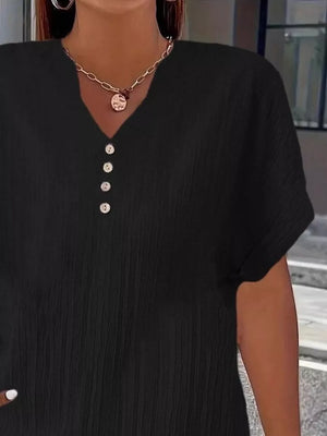 Black textured plus size V-neck t-shirt with decorative buttons and short sleeves.