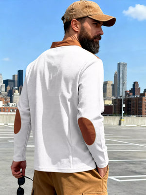 White long-sleeve men's t-shirt with brown elbow patches and collar detail.