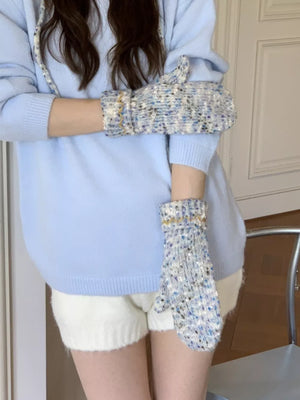 Textured knit mittens in light blue with zig-zag detail and gold trim