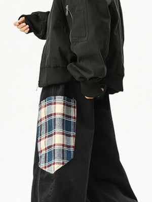 Men's black wide leg sweatpants with a plaid pocket detail.