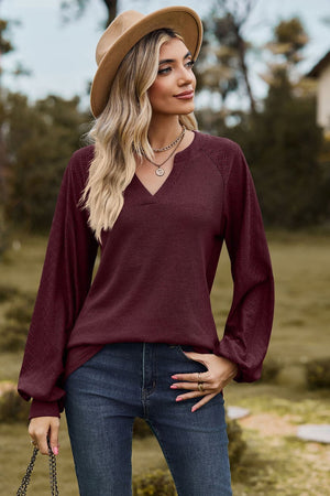 Burgundy waffle knit raglan sweater with laser cut sleeves and v-neck
