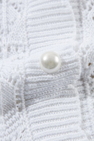 White openwork crochet cardigan with pearl button detail, acrylic knit.