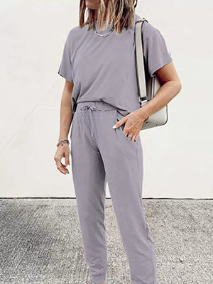 Grey cotton jogger pants with drawstring waist and cuffed ankles.