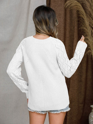 White diamond-cut raglan knit sweater with textured sleeves and a crew neck.