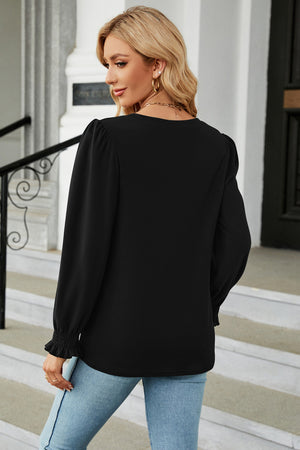 Black smocked cuff puff sleeve blouse with crew neck and long sleeves.