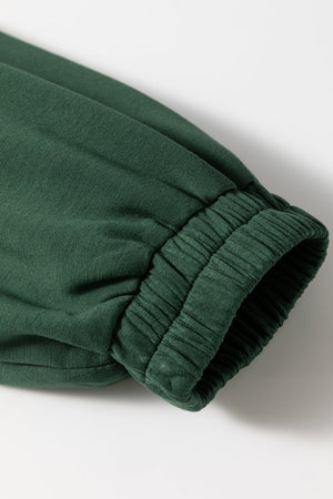 Dark green drawstring waist romper sleeve detail with elastic cuff