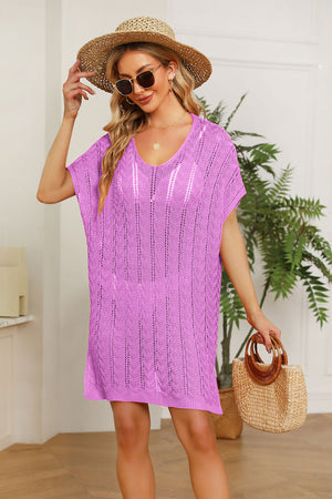 Pink knit swim dress with slit sleeves and a V-neck, featuring a textured pattern.