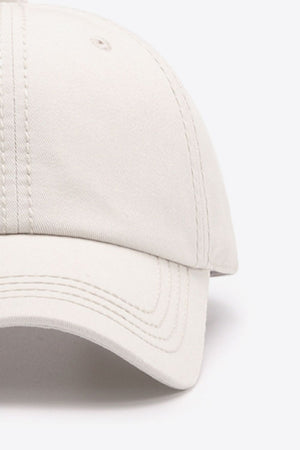 Beige canvas baseball cap with stitched detailing and curved brim.