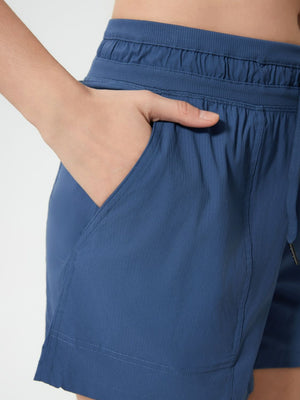 Coastal drawstring utility shorts in dusty blue with elastic waistband and pockets.