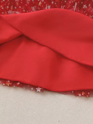 Red baby dress with star-print tulle hem and pom-pom details